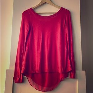 Sweater over a see-through top with open back